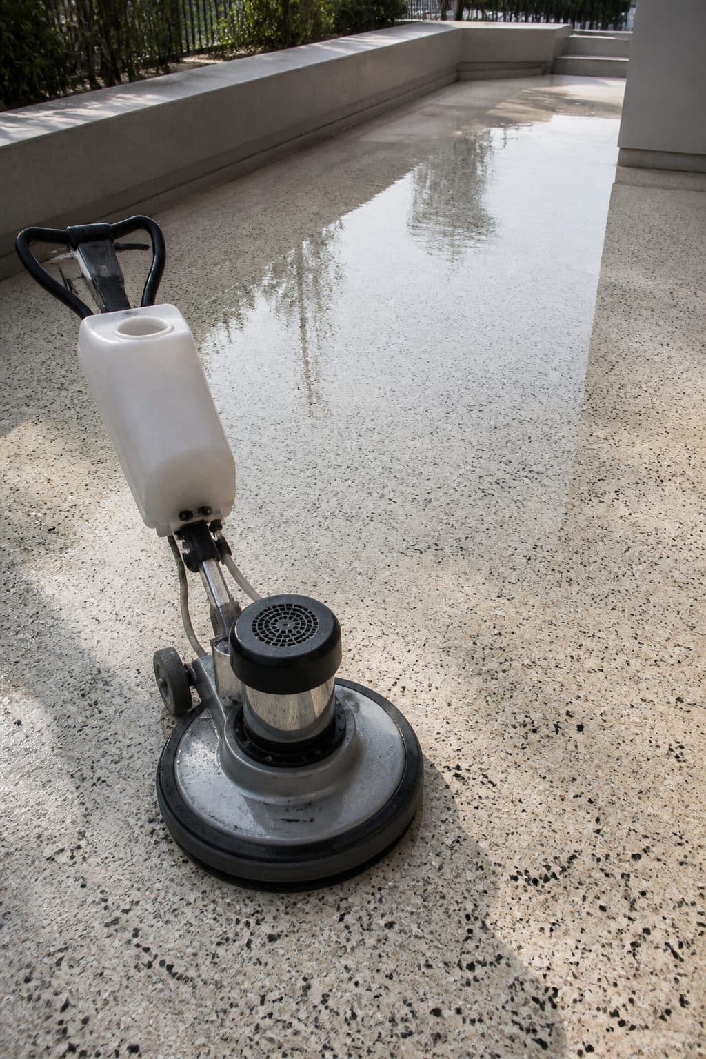 Professional terrazzo floor polishing on an outdoor terrace installation